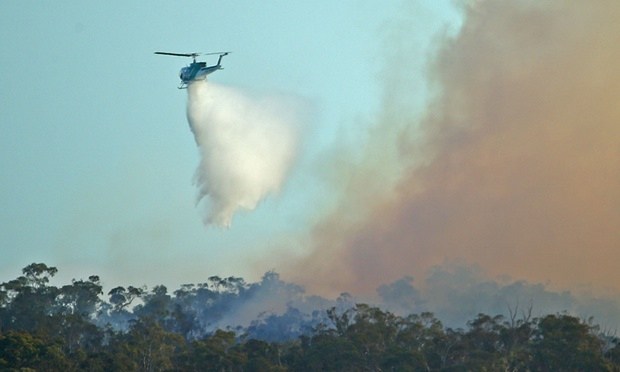 A water bombing helicopter dumps water on a bushfire in Lancefield, Victoria, on Wednesday. Photograph: Scott Barbour/Getty Images