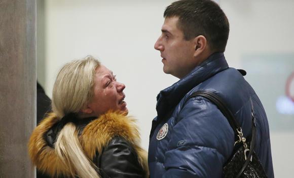 Relatives react after a Russian airliner with 217 passengers and seven crew aboard crashed, as people gather at Russian airline Kogalymavia’s information desk at Pulkovo airport in St. Petersburg, Russia, on Saturday. (AP Photo/Dmitry Lovetsky)