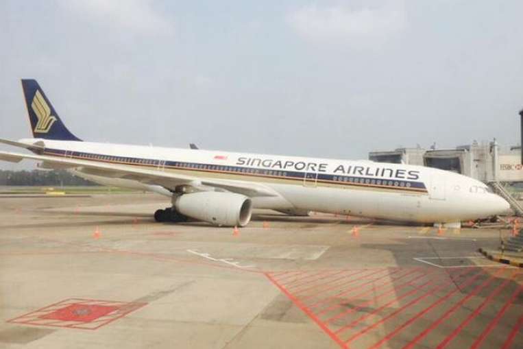 The Singapore Airlines plane lying on its front at Changi Airport, after its nose gear collapsed on Sunday morning. PHOTO: @NOAR85/TWITTER