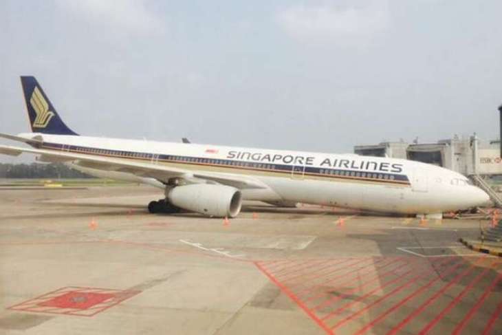 The Singapore Airlines plane lying on its front at Changi Airport, after its nose gear collapsed on Sunday morning. PHOTO: @NOAR85/TWITTER