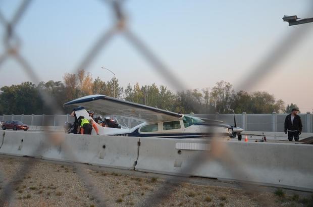 The Cessna 210 Centurion landed by SP Aircraft pilot Jon Brinkerhoff waits to be loaded onto a flatbed trailer after the forced landing Tuesday on Interstate 84 near the Orchard Street exit. Brinkerhoff found the safest place to land after the plane ran out of fuel and could not make it to the Boise Airport. JOHN SOWELL — jsowell@idahostatesman.com