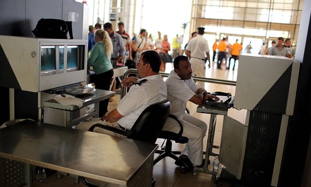 Officials check passengers’ belongings at Sharm el-Sheikh airport. Photograph: Asmaa Waguih/Reuters