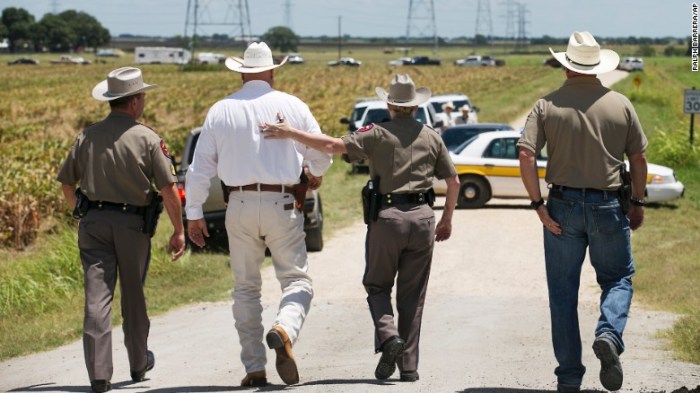 Texas DPS Trooper Robbie Barrera, center right, puts her arm around Caldwell County Sheriff Daniel Law as he arrives on the scene of a hot air balloon crash Saturday. 