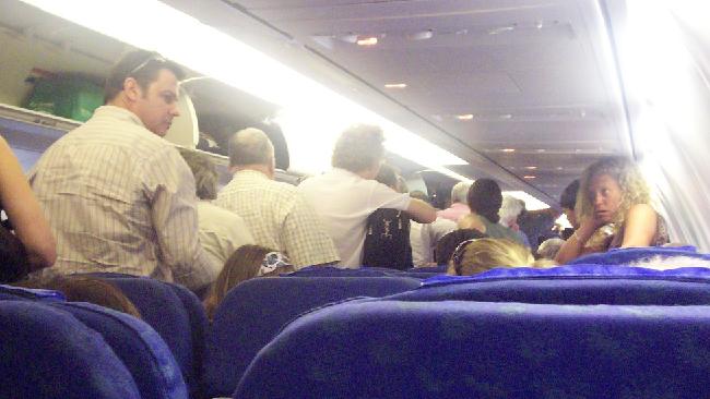 Landing: the time on the flight when we all rush for the exit — only to get stuck in the aisle or left half-standing, half-sitting in our seats. Picture: David Jackmanson