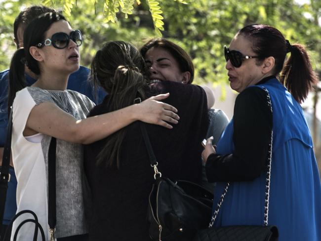 Families of passengers who were flying aboard EgyptAir Flight 804 wait outside a services hall at Cairo airport.