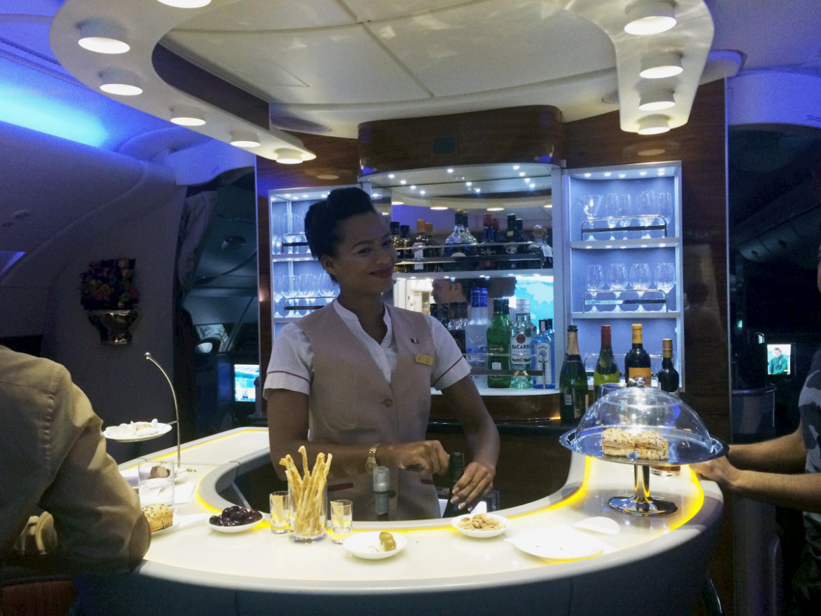 But I didn't forget to take a picture of the absolute coolest thing about the Emirates flight — the lounge! I've been dying to see the A380's bar area for years, and it was even better than I'd imagined. There was a big selection of wine, champagne, and spirits, and flight attendants constantly refreshed the trays of hot and cold snacks in the lounge area. Passengers made small talk around the circular bar and sat on little couches. If felt like a throwback to the golden days of air travel, except most people were in sweatpants and socks.