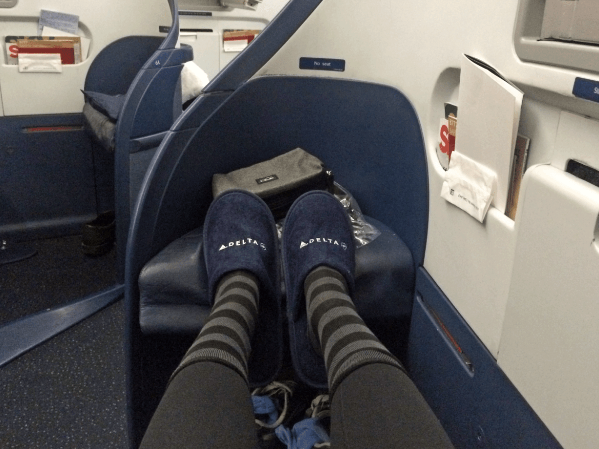 No foot cubby on Delta, but there was still room to stretch out. And I was pretty psyched to have Delta slippers so I didn't have to tie my sneakers when I used the lavatory. The striped socks were from Delta, too. Emirates' socks were plain black, and no slippers. (The little perks get me every time.)