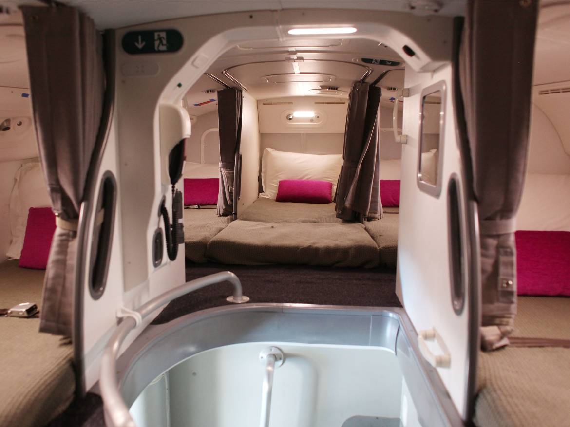 Upstairs are cramped, windowless bedrooms with eight beds (or seven, depending on the airline). This is the cabin's rest area on the Boeing 787 Dreamliner.