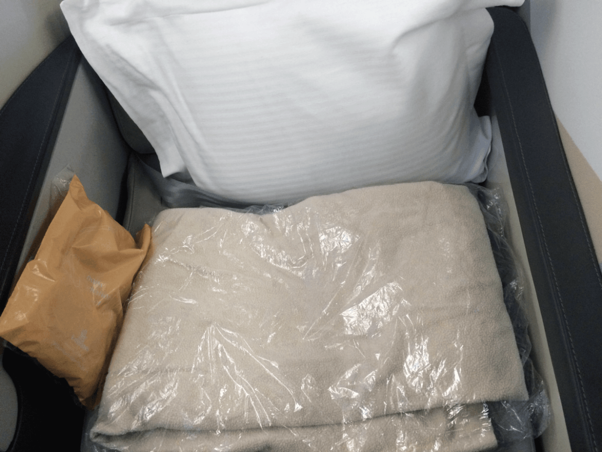 Bedtime! Both business classes had pillows and blankets that were WAY better than anything I've ever seen in coach. On Emirates, flight attendants came around with mattress pads and helped passengers make up their beds.