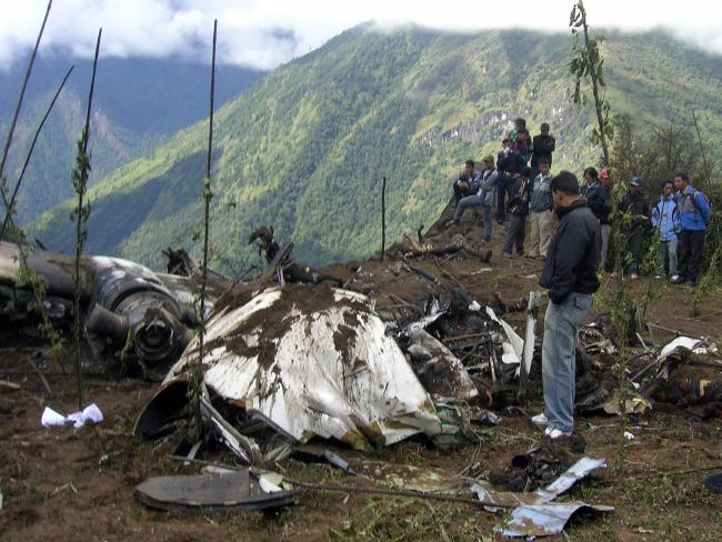 People stand around the wreckage of a Yeti Airlines plane in 2008.Source:News Limited